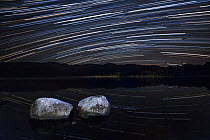 Night sky over Loch Morlich with star trails, Cairngorms National Park, Cairngorms, Scotland, UK, September 2015.