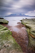 View towards Isle of Rum from Singing Sands Beach, Isle of Eigg, Inner Hebrides, Scotland, UK, April 2014.