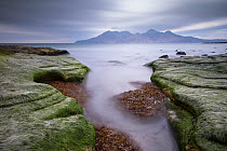 View towards Isle of Rum from Singing Sands Beach, Isle of Eigg, Inner Hebrides, Scotland, UK, April 2014.