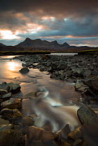 River flowing into Kyle of Tongue in morning light with view to Ben Loyal, Sutherland, Scotland, UK, December 2014.