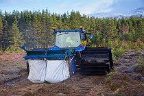 Machine collecting moss brash to distribute on bare peat as part of peatland restoration project, Inshriach, Glenfeshie, Cairngorms National Park, Scotland, UK, January 2015.