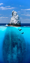 Scuba divers at Roca Partida, a little rock out in the middle of nowhere. Revillagigedo Islands, Revillagigedo Archipelago Biosphere Reserve (Socorro Islands), Pacific Ocean, Western Mexico. Digital c...