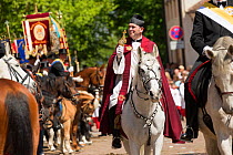 Priest on horseback at the Blutritt (the right of blood) the largest European procession with about 3 000 riders, Weingarten, Baden-Wurtemberg, Germany. May 2016.
