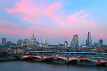 View over Southwark Bridge at Sunset including St Pauls Cathedral and Tower 42, London, England, UK, March 2014.