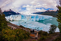 Two people at viewing point overlooking Perito Moreno Glacier, Los Glaciares National Park, Santa Cruz, Patagonia, Argentina. February 2010.