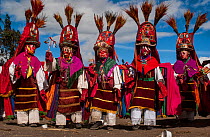 Indigenous Salasaca Indians in traditional masks and headdresses, celebrating the Inti Raymi festival - or Festival of the Sun, Salasaca, Andes, Ecuador, June 2004.