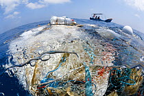 A tangle of fishing nets, lines, hooks and other garbage found floating in the Indian Ocean. There was a small community of fish associated with this trash, but also fish that had been entangled and k...