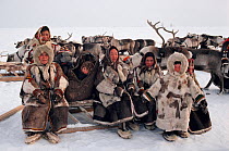 Nenets women and children in traditional reindeer skin clothing at a festival on the tundra. Yamal, Siberia, Russia.