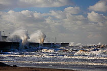 Stormy sea crashing against the sea wall at New Brighton Wirral, Merseyside, UK, January.