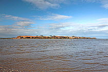 Hilbre Island viewed from the from the east side with rising tide - situated in the mouth of River Dee Estuary. Wirral, UK February 2016.