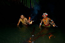 Mentawai women fishing at night, using burning wood for light to attract fish,  Siberut, Sumatra, July 2015