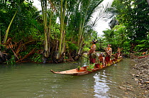 Mentawai women and children riding in dugout canoe, Siberut, Sumatra, July 2015