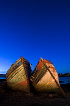 Two old abandonned  trawler boats at dusk, Salen, Mull, Scotland