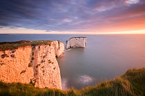 RF - Old Harry Rocks, colourful sunrise looking towards the Isle of Wight, Studland, Dorset, UK. September . (This image may be licensed either as rights managed or royalty free.)