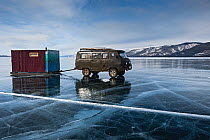 Mini Van trailing Sauna to dive place, Lake Baikal, Siberia, Russia. March 2015.