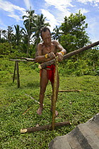 Mentawai  man making a banister for steps to the uma (communal long house)  Siberut Island, Sumatra. July 2016.