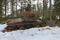 Old rusting military tank outside in snow, Museum Raatteetie, Finland