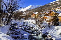 La Valoirette mountain river in winter in front of Valloire ski resort, Savoie in the French Alps. Maurienne Valley, France