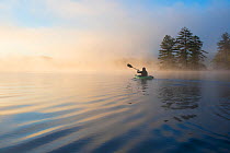RF - Kayaking at dawn. Grafton Pond, Enfield, New Hampshire, United States. Model released. (This image may be licensed either as rights managed or royalty free.)