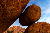 Granite Boulders in canyon, Little Dragoon Mountains in background in sunset light, Texas, USA, August.