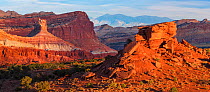 Capitol Reef National Park's contrasting stata in sunset light with the Henry Mountains on the distant horizon.  Utah, America, USA, October.