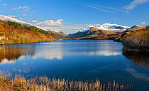 Llyn Padarn viewed from the northern end towards LLanberis with Mount Snowdon to the right in the background in late afternoon light, Snowdonia, North Wales, UK, March.