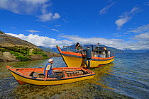 Local fishermen and boats setting out to collect Chilean blue mussels (Mytilus chilensis) Comau Fjord, Patagonia, Chile, January 2013