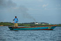 Fishermen fishing in the polluted Balikpapan bay, Balkipapan, Indonesia
