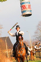 Costumed rider participating in Tondeslagning, in the streets of Store Magleby, Denmark. Tondeslagning is an ancient tradition to bring good crops by smashing a barrel which is supposed to contain the...