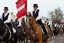 Costumed riders participating in Tondeslagning, in the streets of Store Magleby, Denmark. Tondeslagning is an ancient tradition to bring good crops by smashing a barrel which is supposed to contain th...