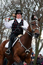 Costumed rider participating in Tondeslagning, in the streets of Store Magleby, Denmark. Tondeslagning is an ancient tradition to bring good crops by smashing a barrel which is supposed to contain the...