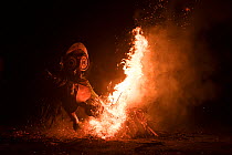 Baining men in traditional fire dance ceremony. Men enter a trance like state and dance around the fire in animal masks to contact the spirit world. Papua New Guinea, March 2017.