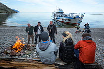 Tourists on land excursion to the shore from the liveaboard dive boat 'Valeria', Lake Baikal, Siberia, Russia.