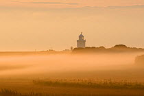 North Foreland Lighthouse and sea mist over agricultural fields. Kent, UK. July