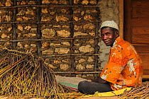 A man weaving together fishing nets from reeds on Ibo Island, in the Quirimbas Archipelago off the coast of northern Mozambique. June 2011
