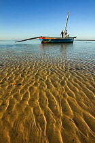 Men prepare their dhow for a late-morning fishing trip off the coast of Mossuril, northern Mozambique. June 2011