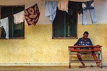 Boy studying  in front of a dormitory in Mossuril, northern Mozambique. June 2011