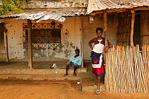 Two girls watching passers-by in Mossuril, Mozambique. June 2011