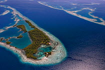 Aerial view of channel through southern Belize barrier reef, with house on small caye. Near Placencia, Belize Barrier Reef Reserve System UNESCO Natural World Heritage Site, Central America.