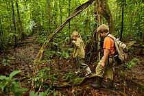 Children, Russell and Jessica Laman hiking in rainforest, Gunung Palung National Park, Borneo. August 2010 Model released.