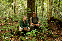 Photographer Tim Laman and Cheryl Knott taking a break while following orangutans, Gunung Palung National Park, Borneo. August 2010 Model released.