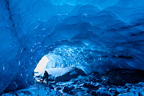 Explorer in Ice cave in Porsmorck, Iceland, February 2016.