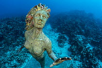 Statue of a mermaid 'Amphitrite', placed underwater on a coral reef as an attraction for divers. George Town, Grand Cayman, Cayman Islands, British West Indies. Caribbean Sea.