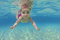 RF - Baby age five months, swimming underwater in the ocean.  Caribbean Sea, Cayman Islands, British West Indies. Model released. (This image may be licensed either as rights managed or royalty free.)