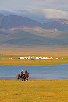 Horse riders and yurts by Song Kul Lake, Kyrgyzstan. August 2016.