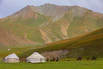 Tash Rabat yurts and horse riders. Kyrgyzstan. August 2016.