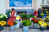 Woman selling flowers at Farmers' market, Funchal, Madeira Island, Portugal, March 2016.