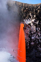 RF - Hot lava from the 61G flow from Kilauea Volcano entering the Pacific Ocean from the open end of a lava tube at the Kamokuna entry in Hawaii Volcanoes National Park, producing steam explosions, Ka...