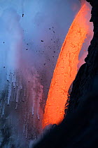 RF - Hot lava from the 61G flow from Kilauea Volcano entering the ocean from the open end of a lava tube at the Kamokuna entry in Hawaii Volcanoes National Park, producing steam explosions, Kalapana,...