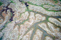 Aerial view of eroded banks and river with suspended load, caused by deforestation, central Madagascar, October 2008.